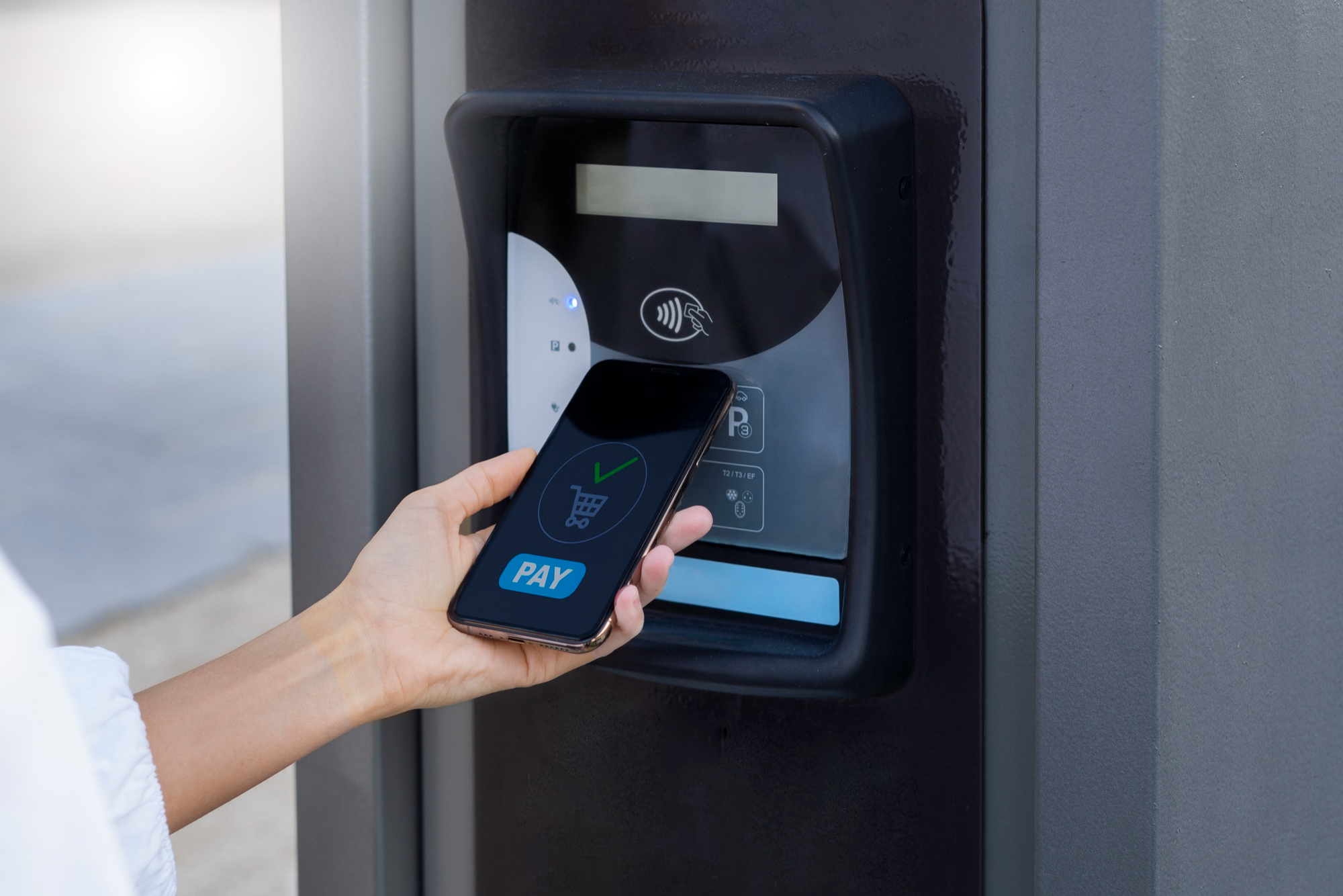 Individual paying with a smartphone, showcasing the convenience of an access control system for transactions